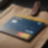 A close-up of a Best Buy credit card resting on a shopping bag filled with electronics.